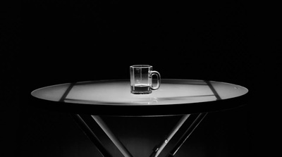 a glass of water sitting on top of a table