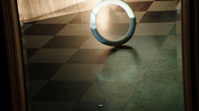 a circular object sitting on top of a checkered floor