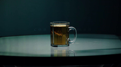 a glass of tea on a glass table