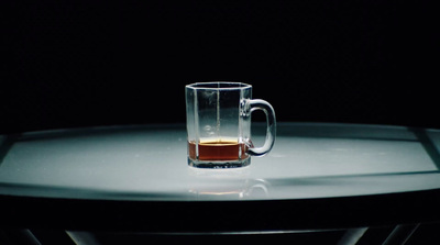 a glass of beer sitting on top of a table