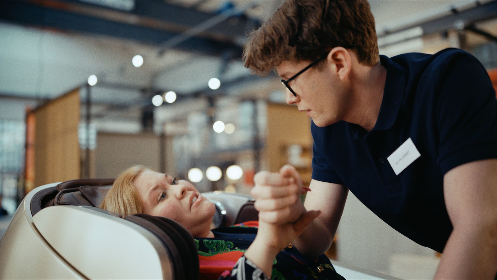 a man helping a woman put her hand on her shoulder