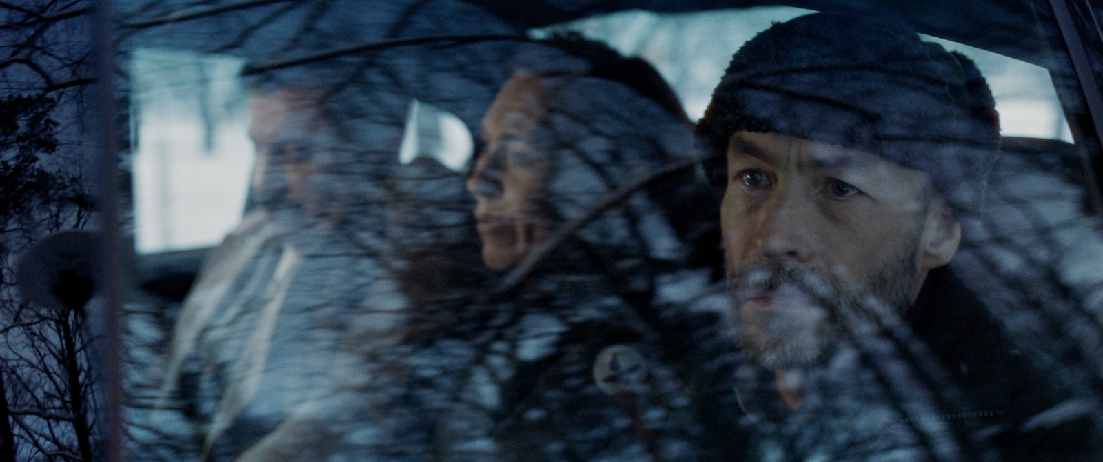 a man and a woman sitting in a car