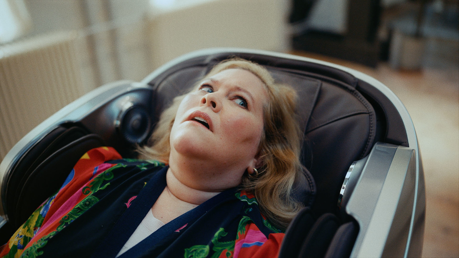 a woman laying in a chair with her eyes closed