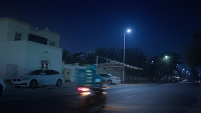 a car driving down a street at night