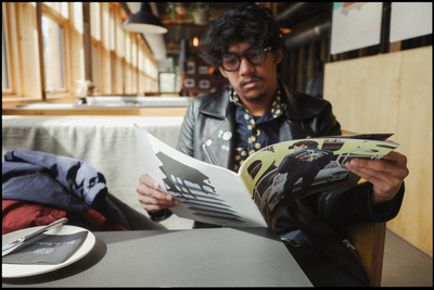 a man sitting at a table reading a book