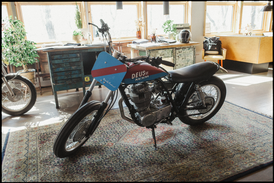 a motorcycle parked on top of a rug in a room