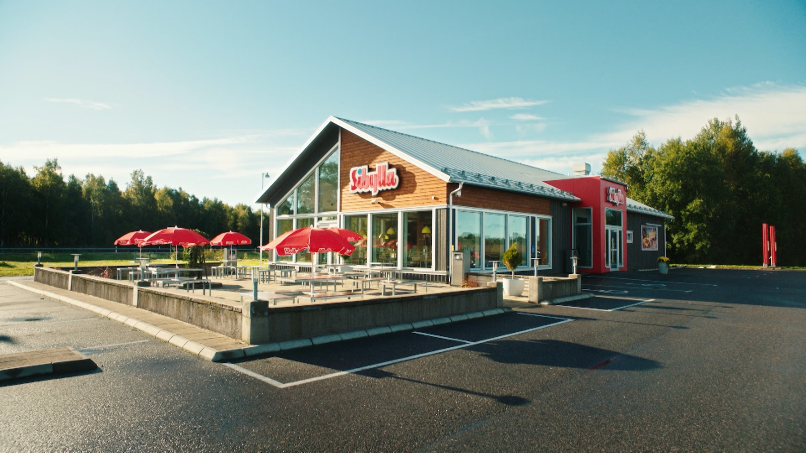 a restaurant with red umbrellas outside of it