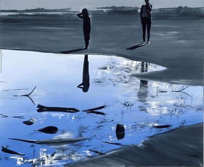 a couple of people standing on top of a beach