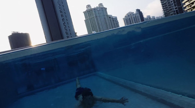 a man is swimming in a large swimming pool