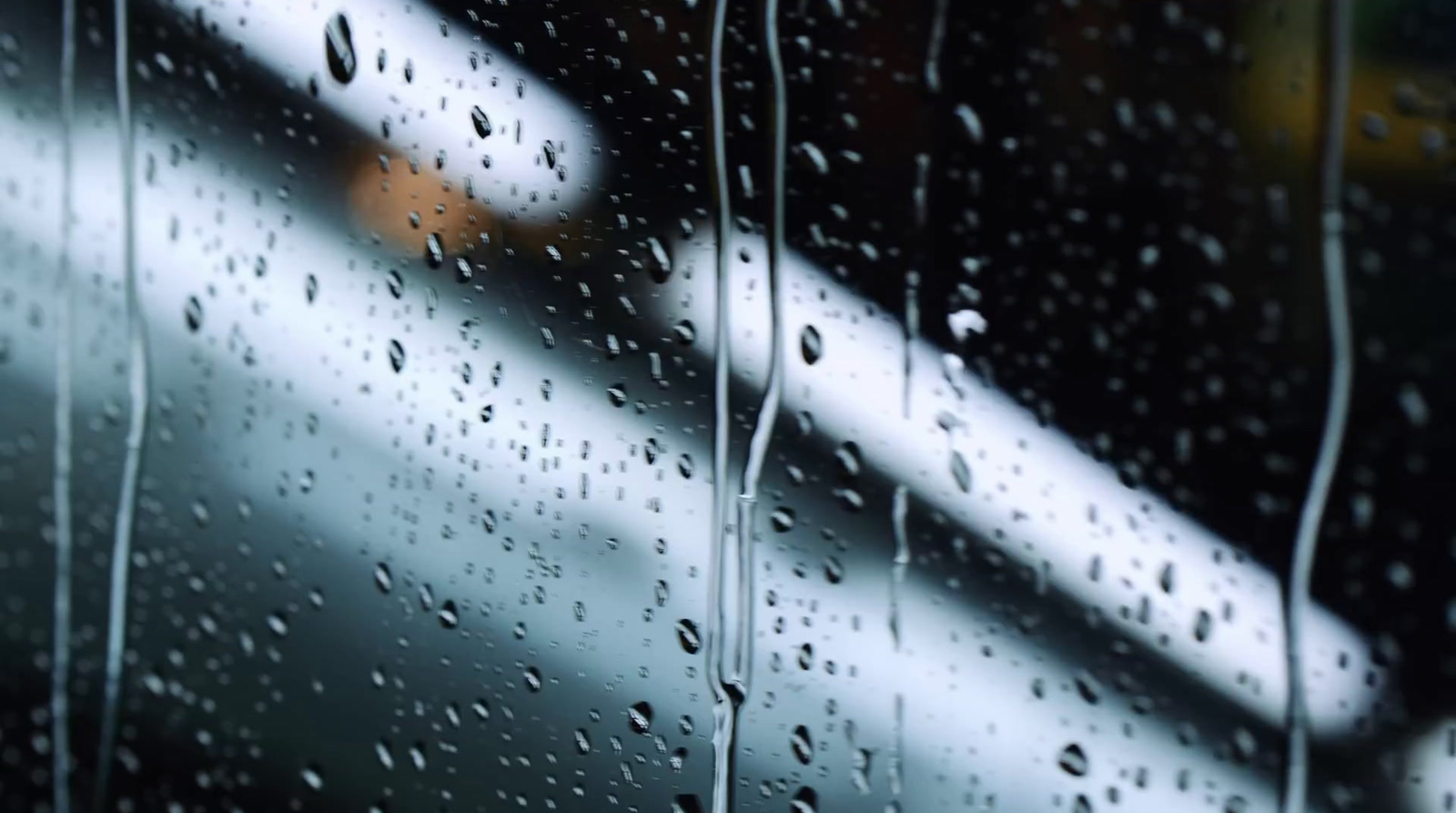 rain drops on a window with a blurry background