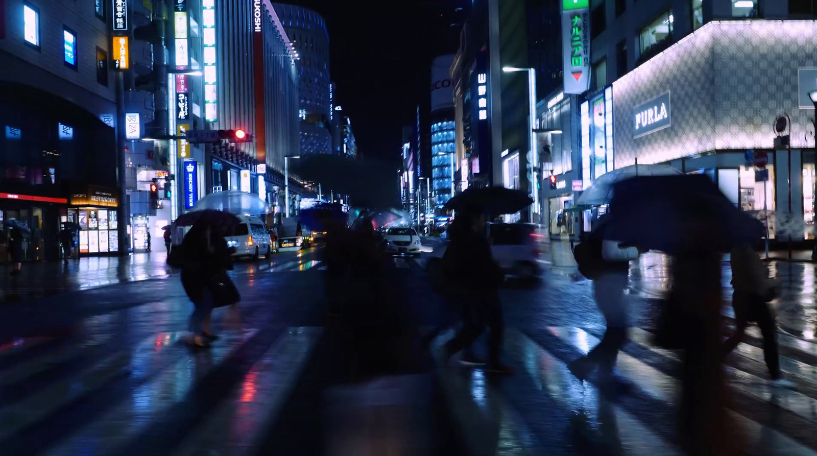 a group of people walking down a street holding umbrellas