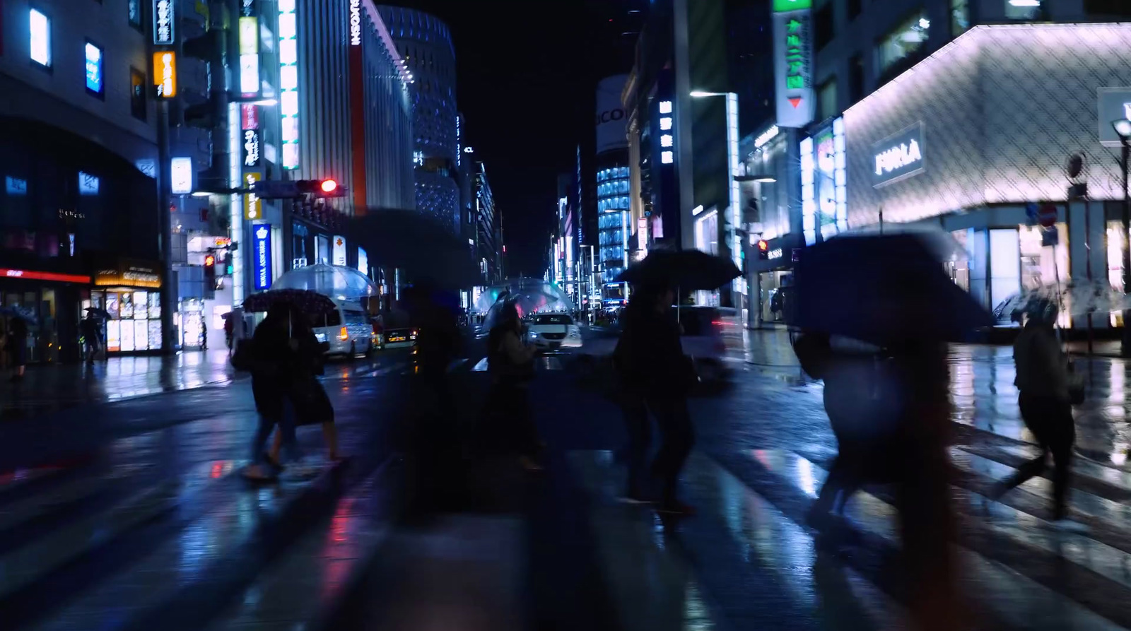 a group of people walking down a street holding umbrellas