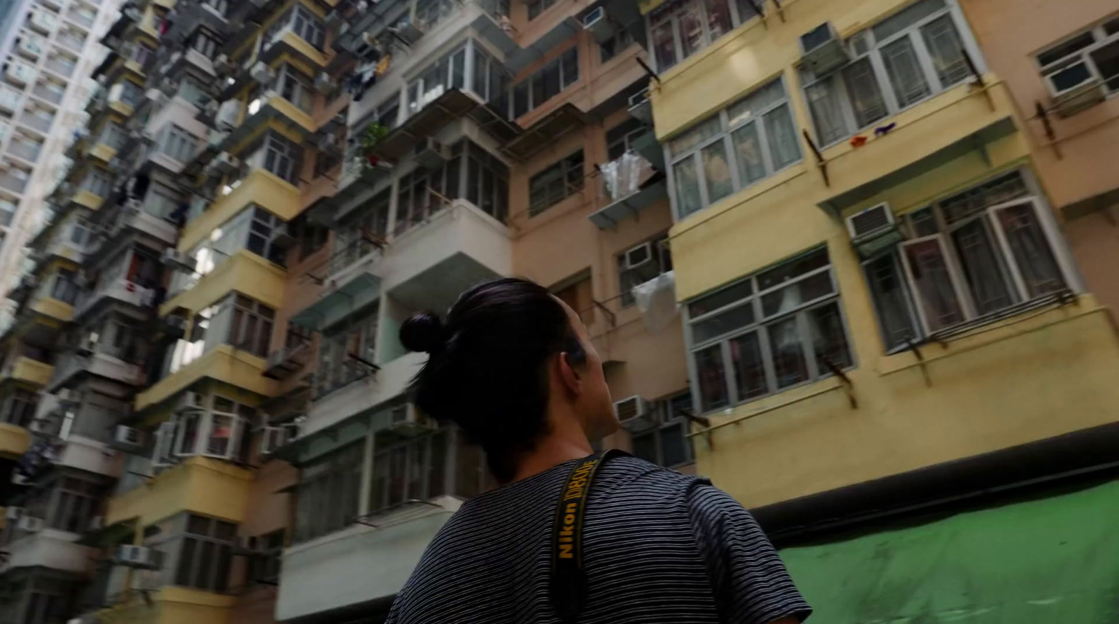 a woman standing in front of a tall building