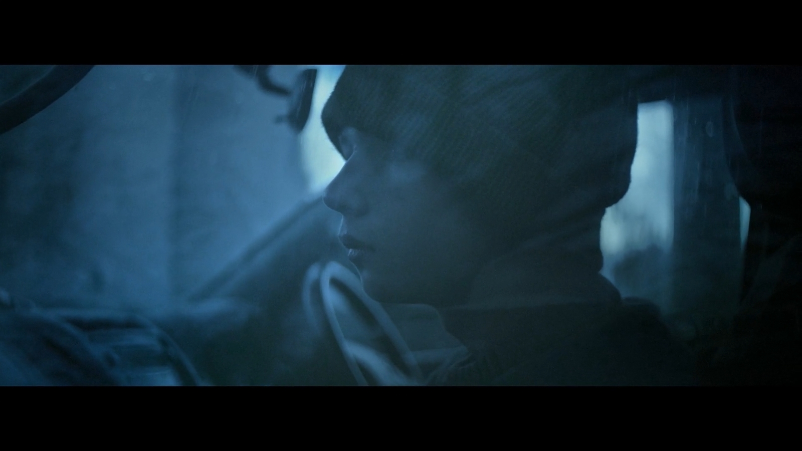 a man sitting in a car in the dark