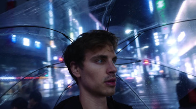 a man holding an umbrella in a city at night