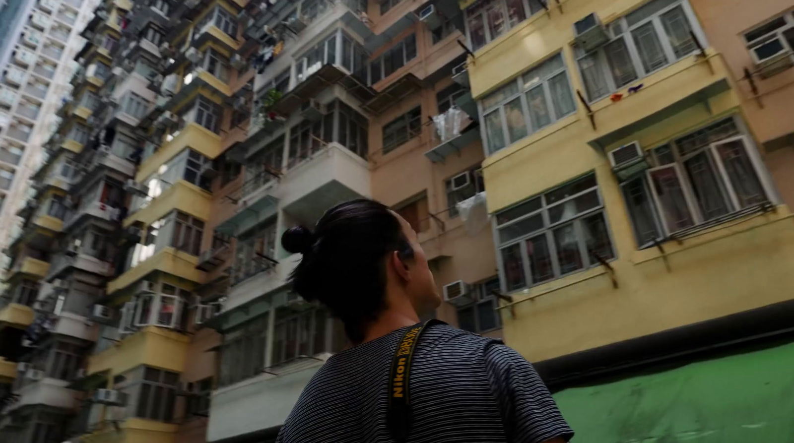 a woman standing in front of a tall building