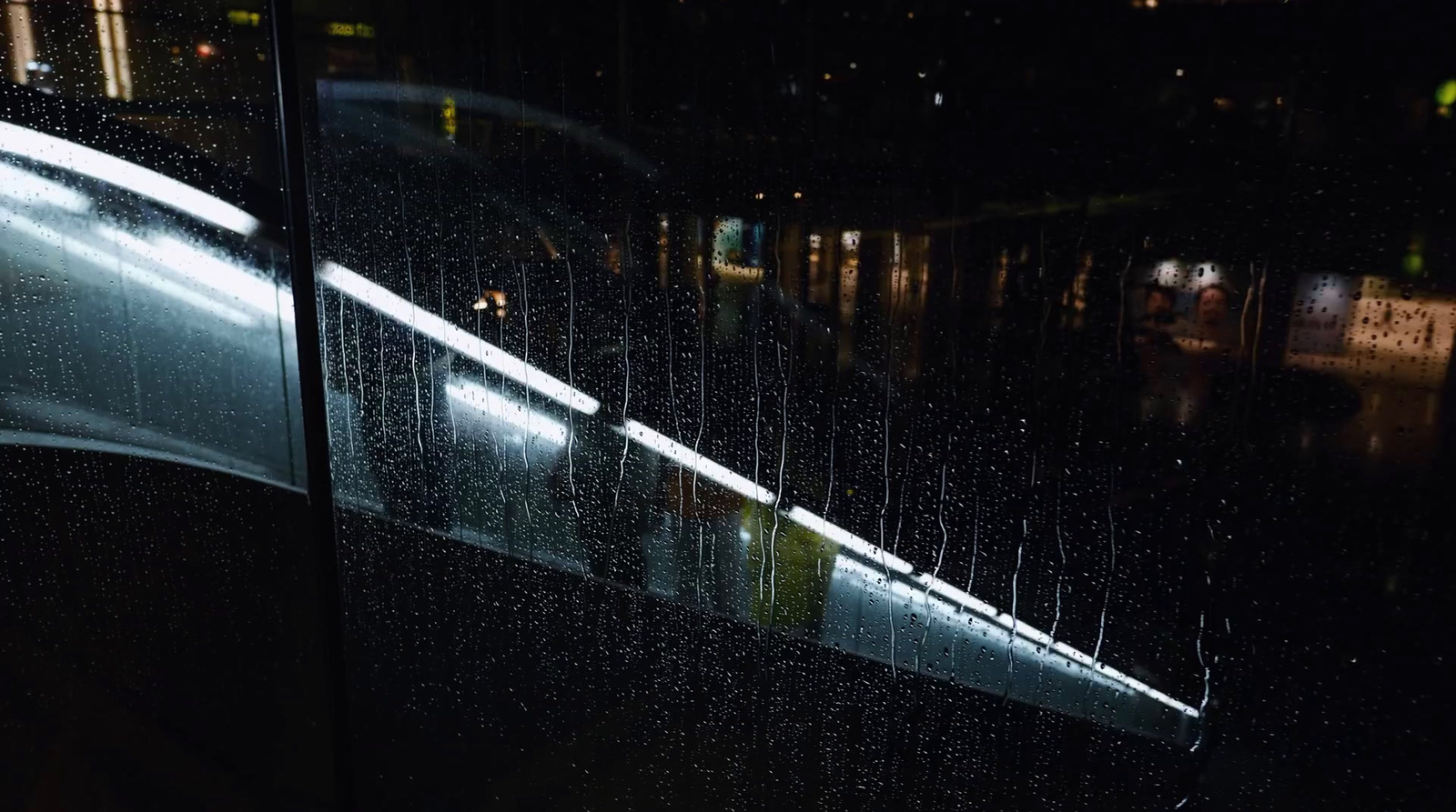 a window with rain drops on it at night