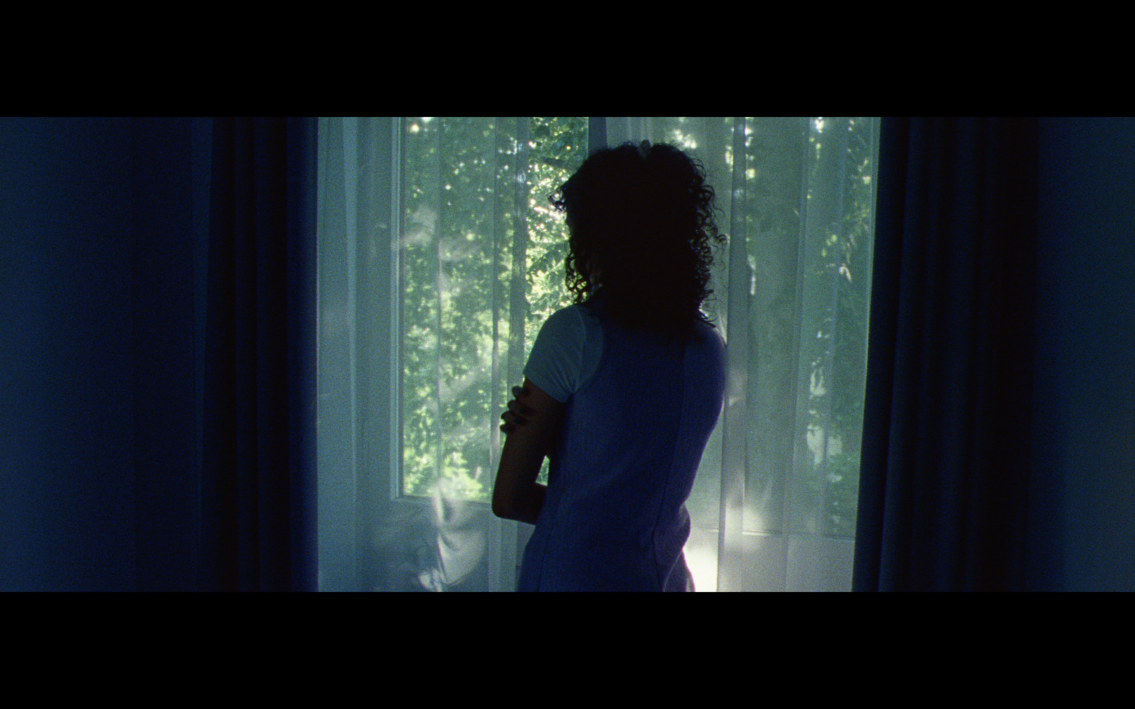 a woman standing in front of a window