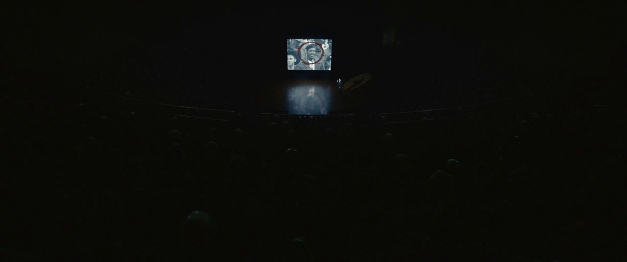 a person standing on a stage in the dark