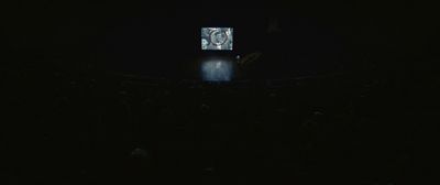 a person standing on a stage in the dark