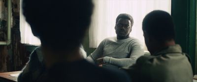 a man sitting in front of a mirror in a room