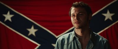 a man standing in front of a flag