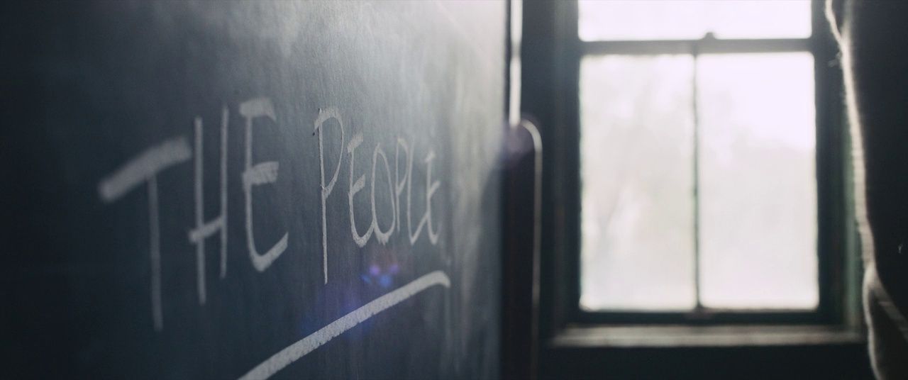 a blackboard with writing on it in front of a window