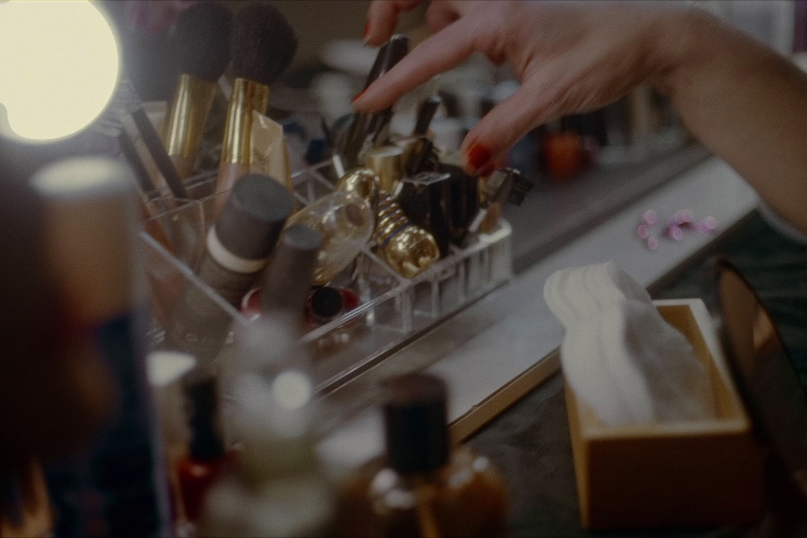 a close up of a person putting makeup on a counter