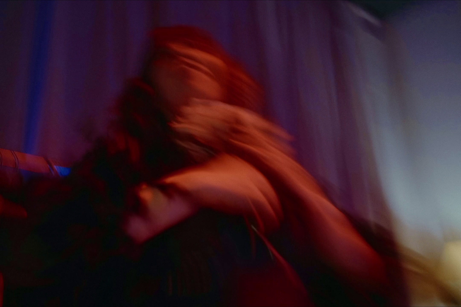 a blurry photo of a woman in a dark room