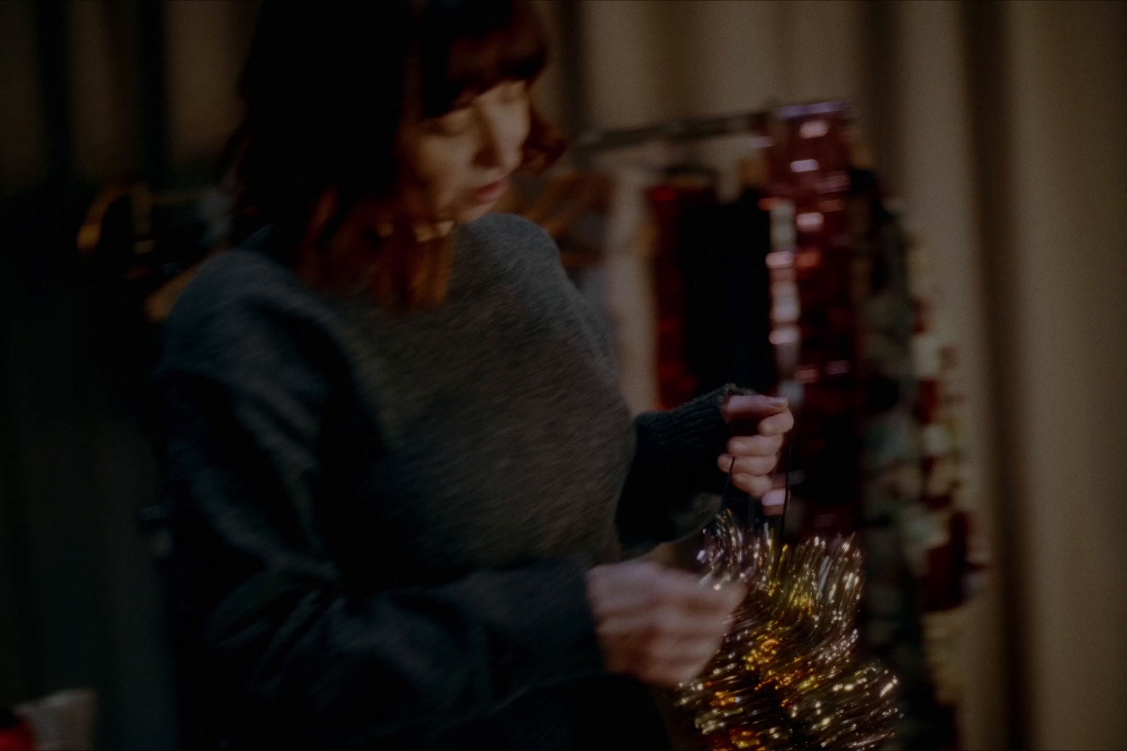 a woman holding a christmas tree in her hands