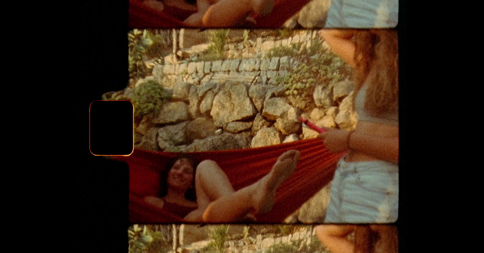 a woman laying in a hammock in the shade