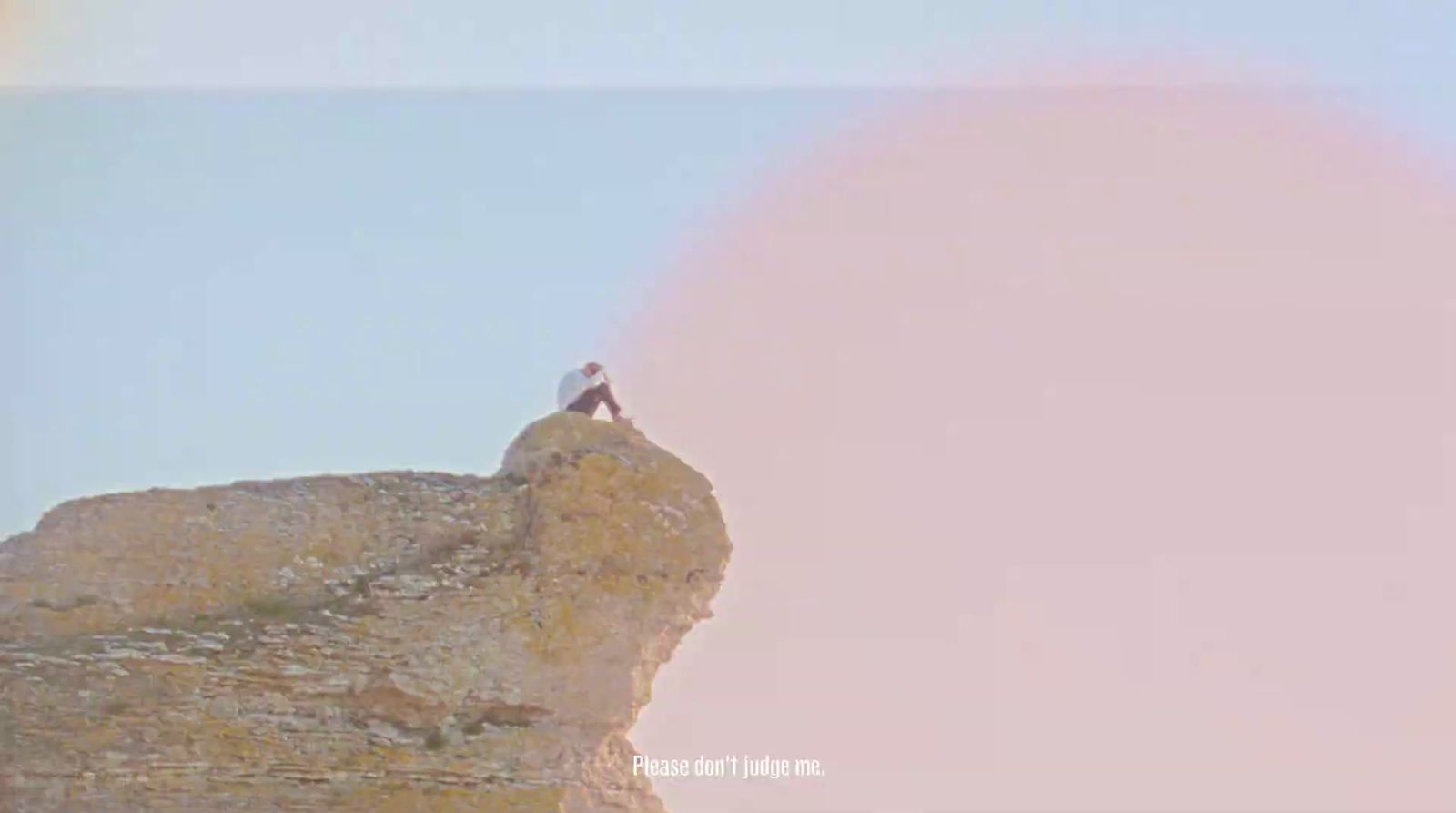 a person standing on top of a large rock