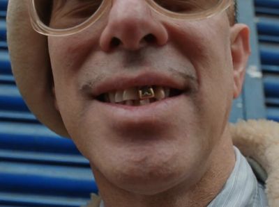 a close up of a person wearing glasses and a hat