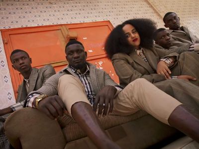 a group of people sitting on top of a couch