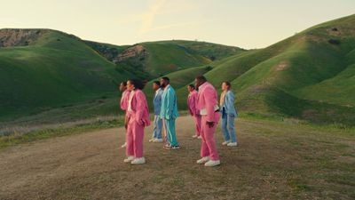 a group of people standing on top of a dirt road