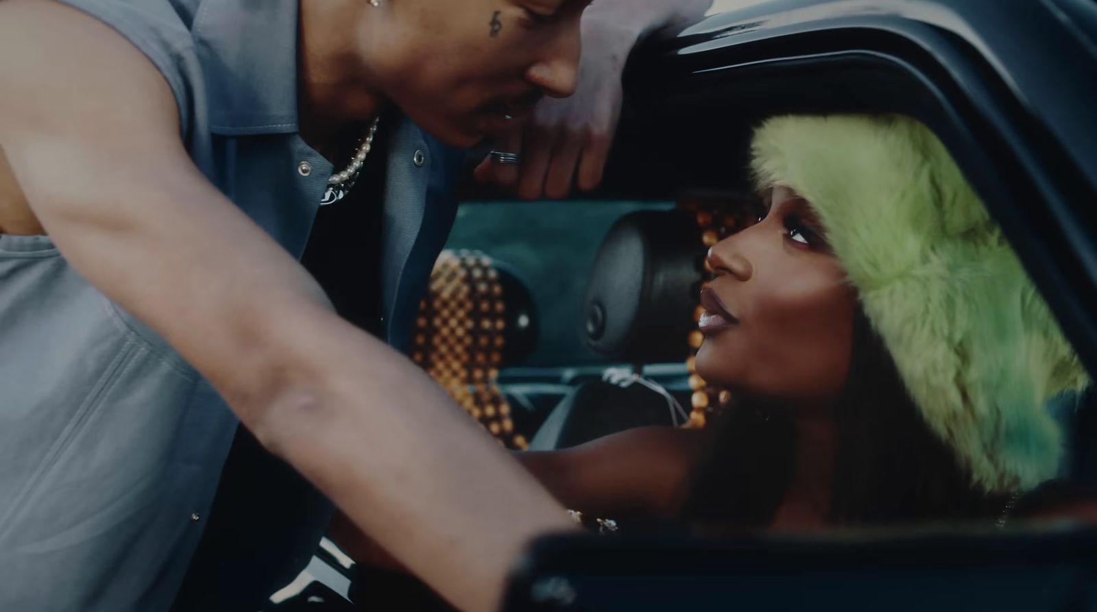 a man and a woman in a car looking at each other