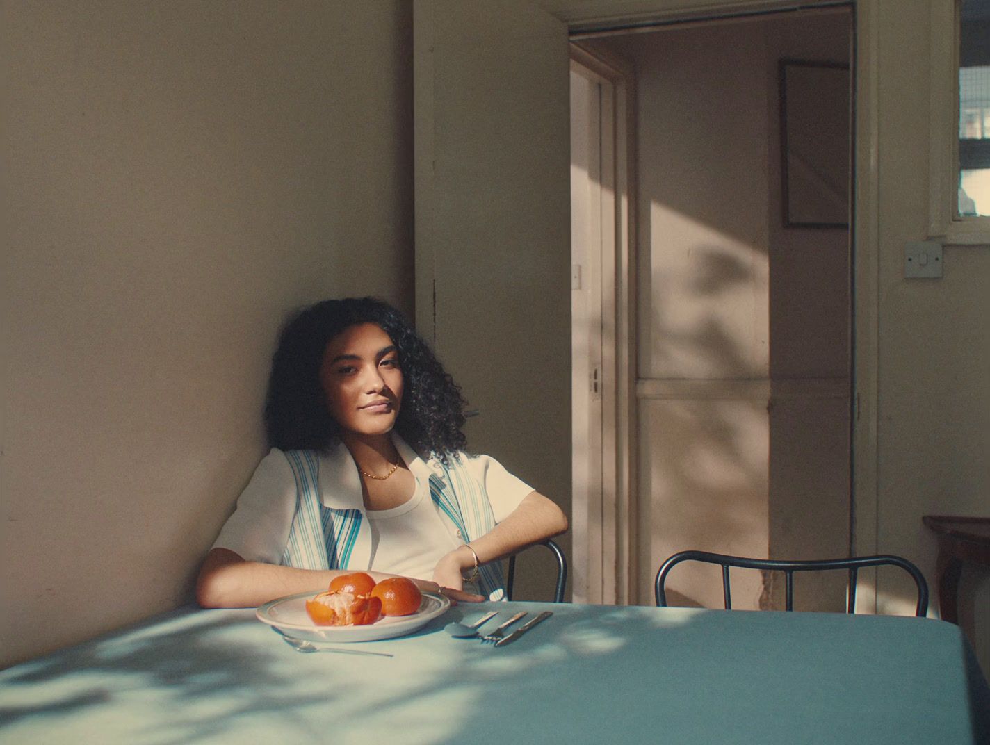 a woman sitting at a table with a plate of food