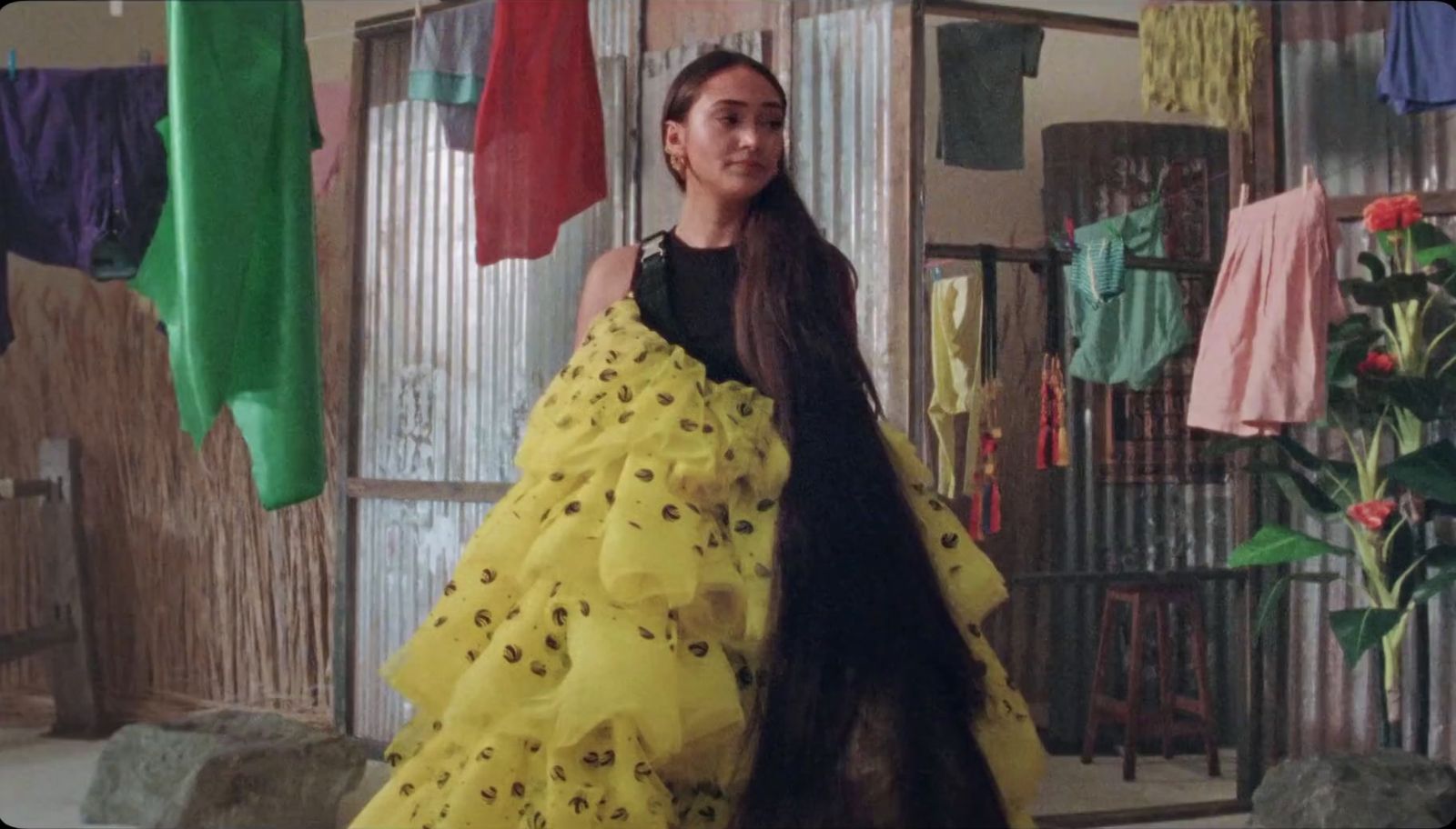 a woman in a yellow dress standing in a room