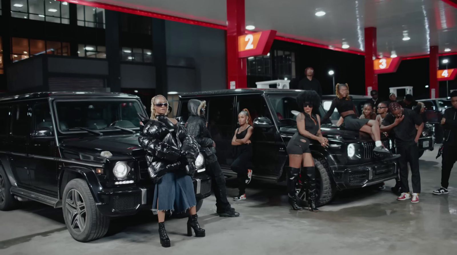 a group of people standing around a black jeep