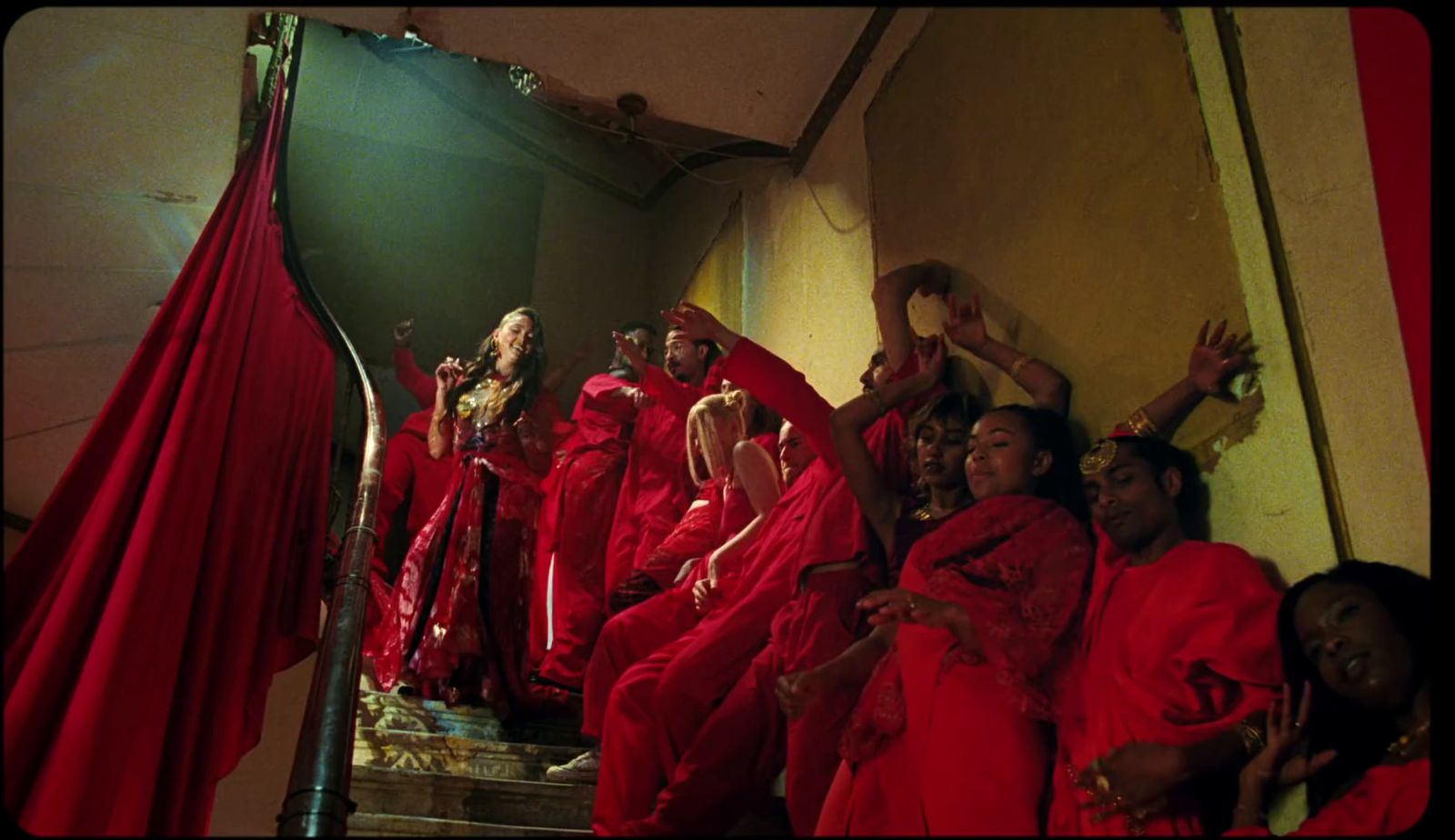 a group of women dressed in red sitting on a staircase