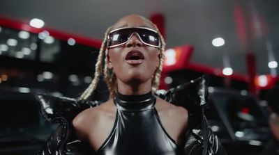 a woman wearing sunglasses and a leather outfit