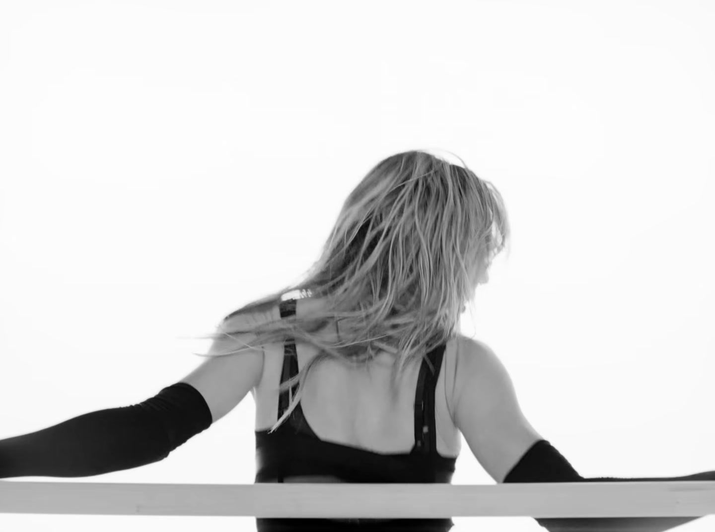 a woman holding a surfboard in her hands