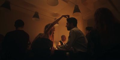 a group of people sitting around a table in a room