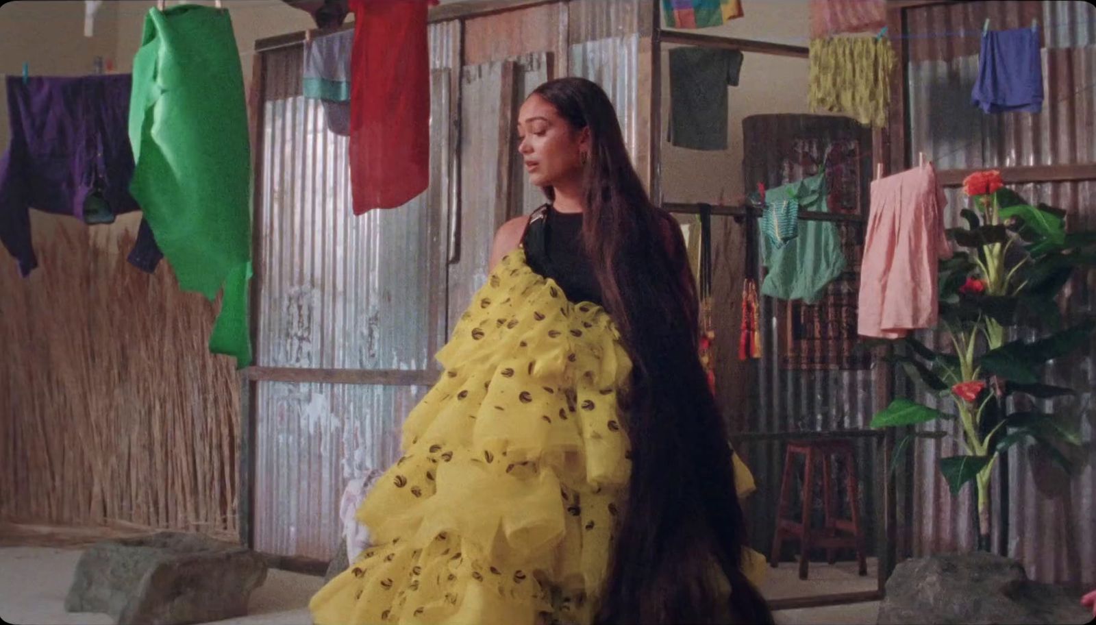 a woman in a yellow dress standing in a room