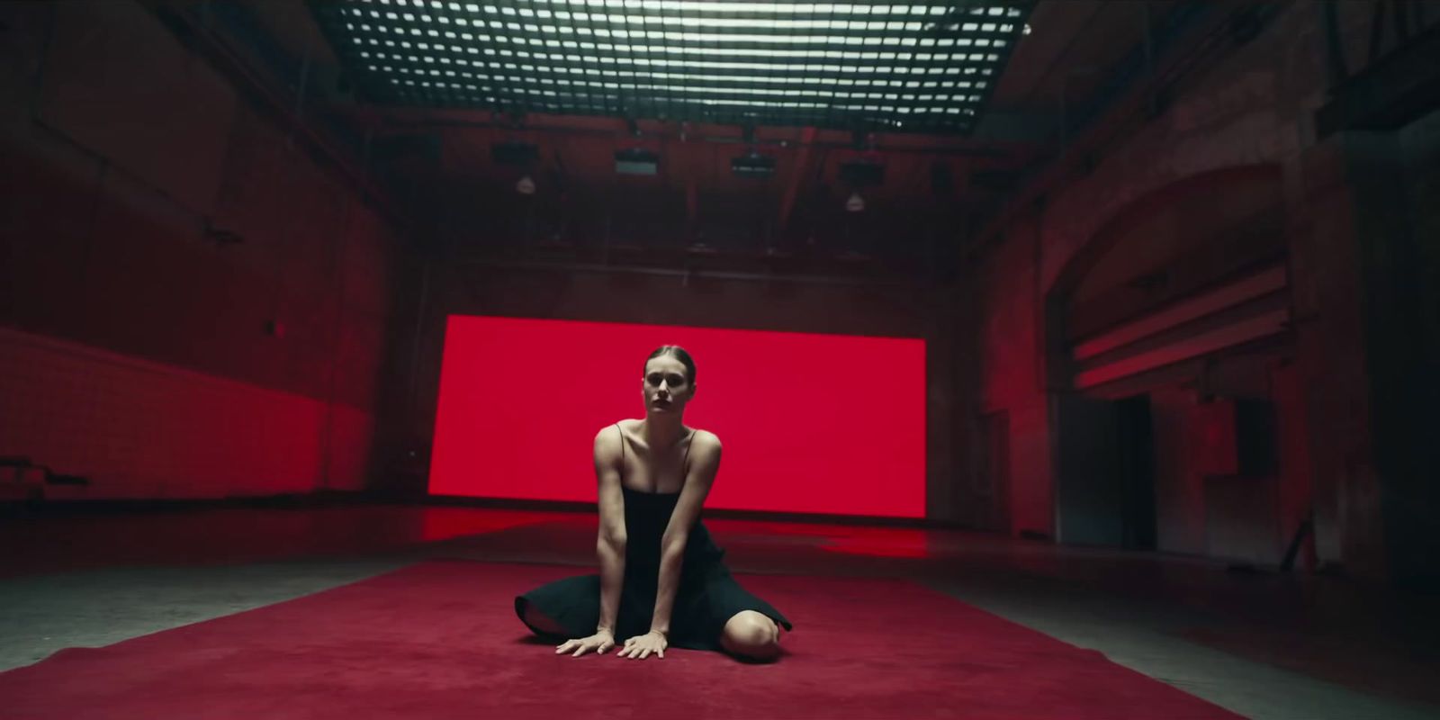 a woman sitting on the floor in a red room