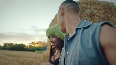 a man standing next to a woman in a field