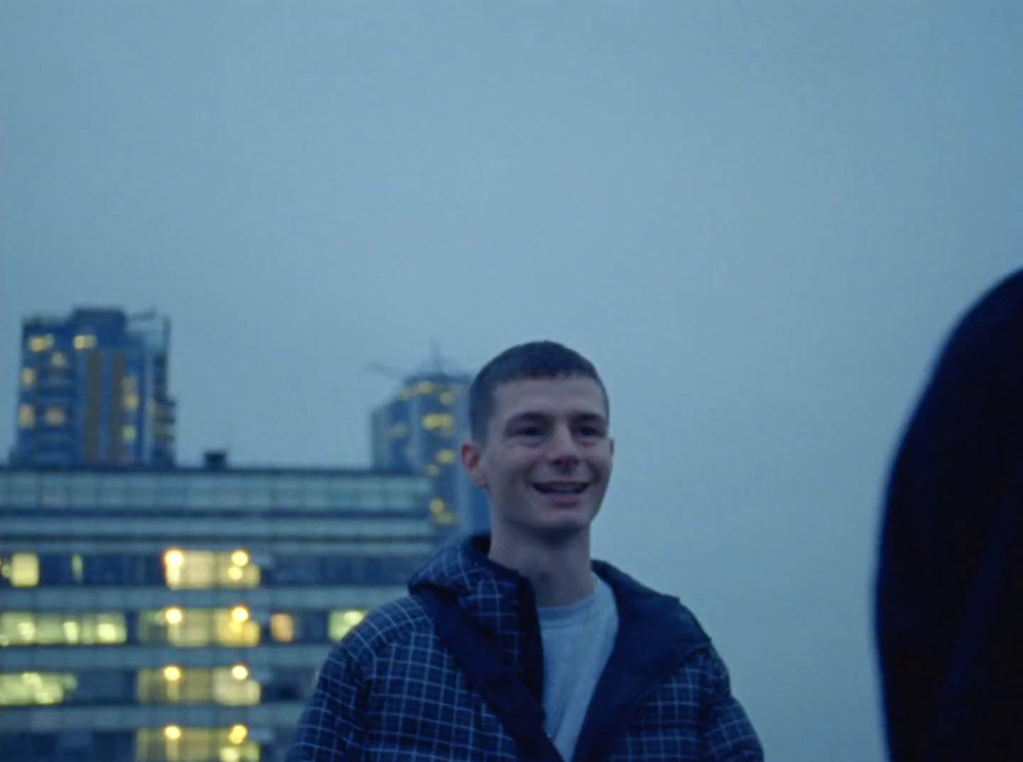 a man standing in front of a tall building