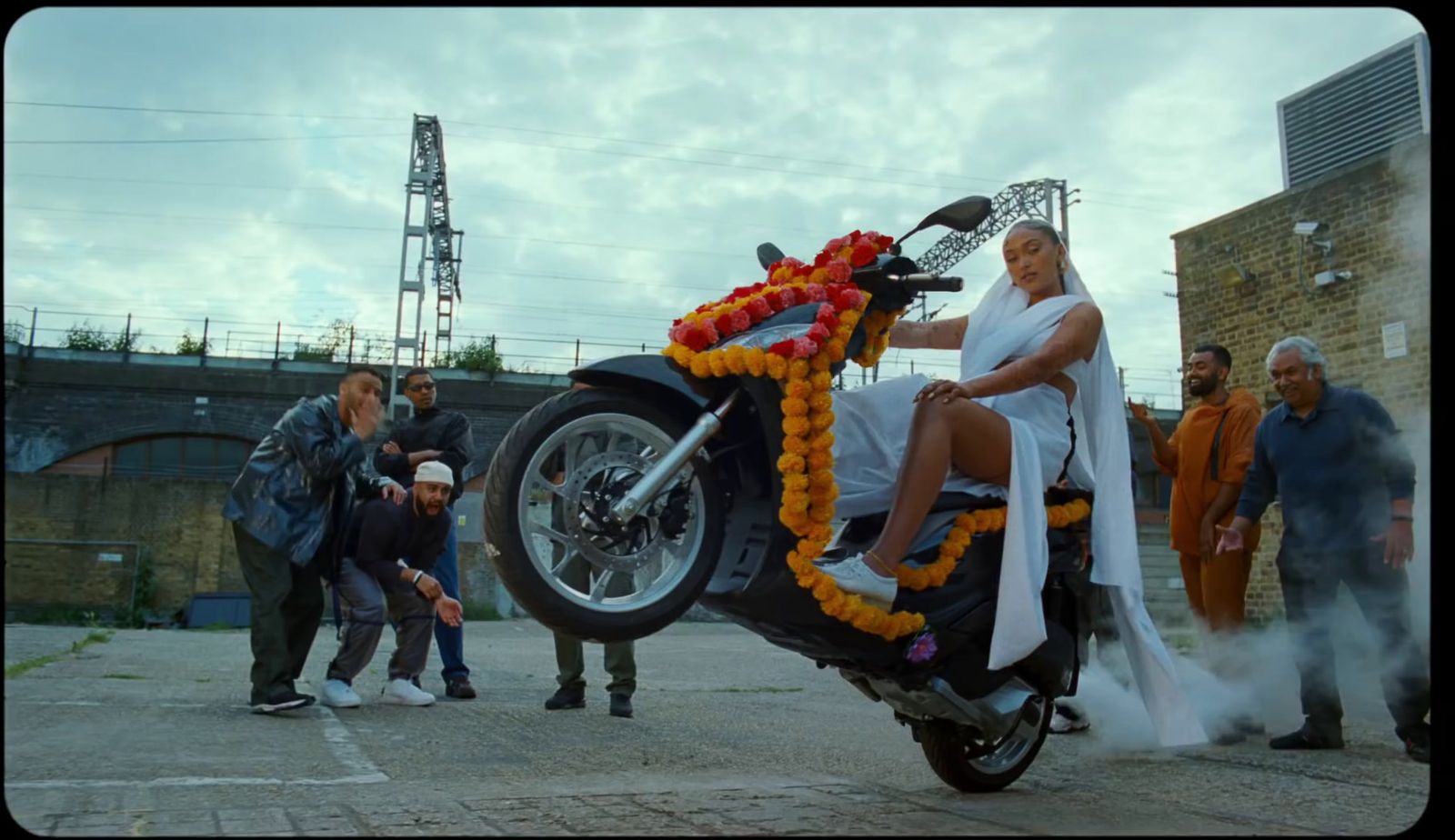 a woman in a white dress sitting on a motorcycle