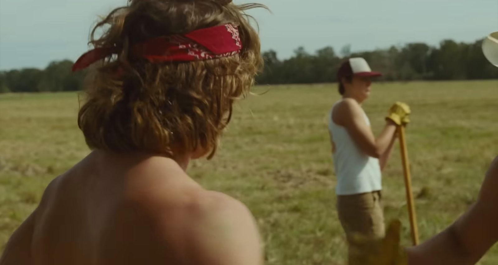 a couple of people that are standing in a field