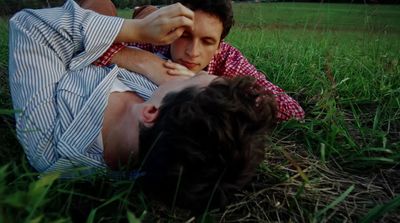 a man laying on the ground in the grass